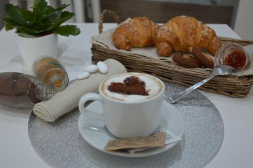 a cup of coffee and croissants on a table at Ca dei Nobili in Genova