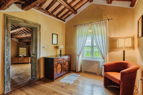 a living room with a chair and a mirror at Villa Stanzia Cocci in Brtonigla