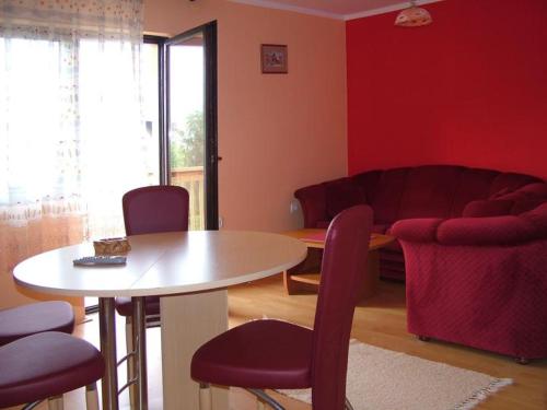 a living room with a table and chairs and a couch at Guesthouse Vila Stakic in Zlatibor
