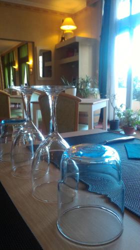 a table with three wine glasses on top of it at Le Saint Christophe in Cosne Cours sur Loire