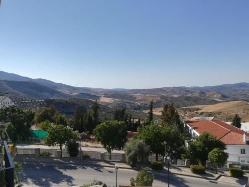 a view of a town with mountains in the background at Casas PARAJE NATURAL in Zahara de la Sierra