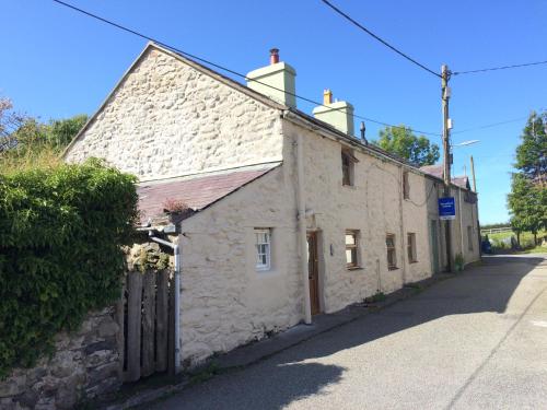 an old stone building on the side of a street at No21 Hop to Zipworld in Bethesda