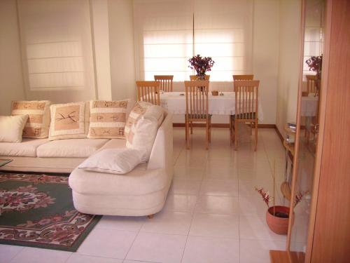 a living room with two white couches and a table at Intheminhohouse in Amorosa