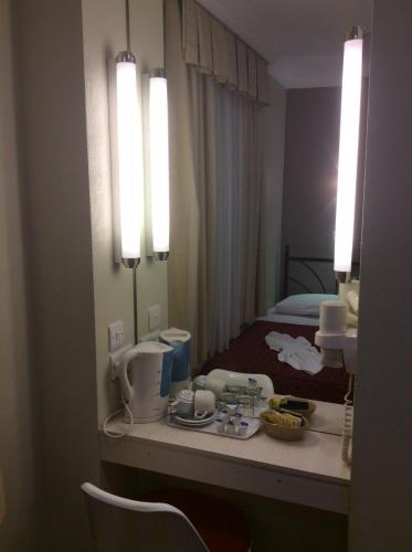 a hotel room with a counter with a mirror at Central Hotel in London