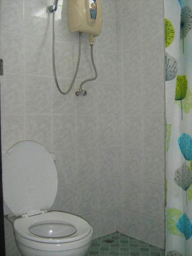a bathroom with a toilet and a phone on the wall at Lamoon Lamai Residence & Guesthouse in Lamai