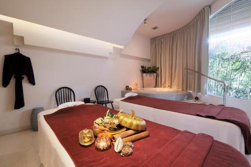 a hotel room with two beds and a table with food at LiT BANGKOK Hotel in Bangkok