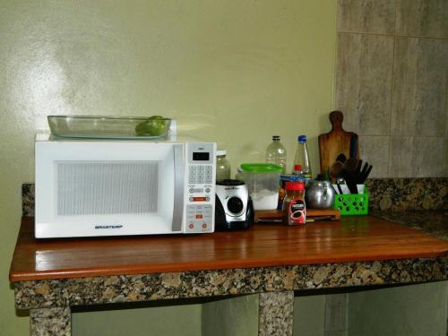 a microwave sitting on top of a counter at Sharing Home I in Três Coroas
