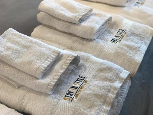 a group of white towels sitting on top of a bed at Stay in Style at Nimman R306AB in Chiang Mai
