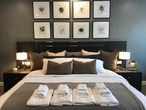 a bedroom with a bed with two towels on it at Stay in Style at Nimman R306B in Chiang Mai