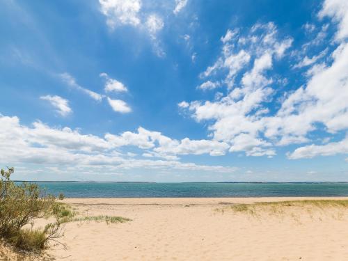 a sandy beach with the ocean and clouds in the sky at Anchor Belle Holiday Park in Cowes