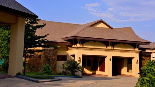 a large house with a brown roof at Emerald Palace Hotel in Nay Pyi Taw
