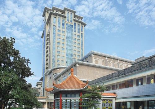 a large tall building with a pagoda in front of a building at Panyu Hotel in Guangzhou