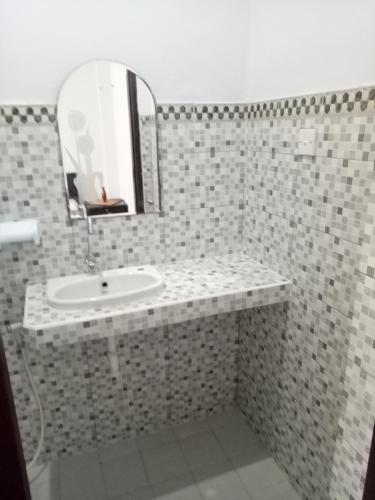 a bathroom with a sink and a mirror at Yoga's House in Ubud
