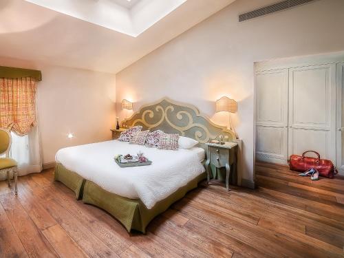a bedroom with a large bed with a large headboard at Casa del Vino della Vallagarina in Isera