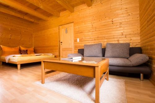 a living room with a couch and a coffee table at Einfach.Ausspannen in Neumarkt im Mühlkreis