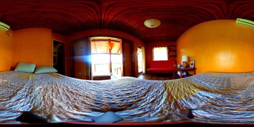 a bedroom with a large bed in a room at Guerrera Rice Paddy Villas in Mambajao