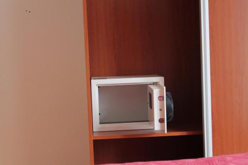 a small white tv sitting on a shelf at Hotel Agorreta in Salinas de Pamplona