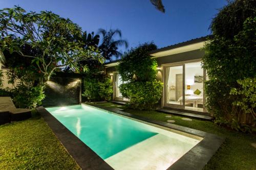 a swimming pool in the backyard of a house at VILLA Nuri Merah 1 in Kerobokan