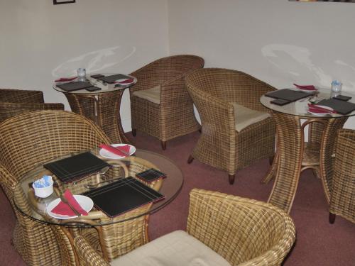a group of tables and chairs in a restaurant at Beeches Guest House in Dyce