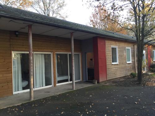 a small house with a porch and windows at Domaine de Bel Air in Cérans-Foulletourte