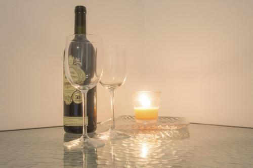 a bottle of wine and two glasses on a table at Lux dodo in Dramalj