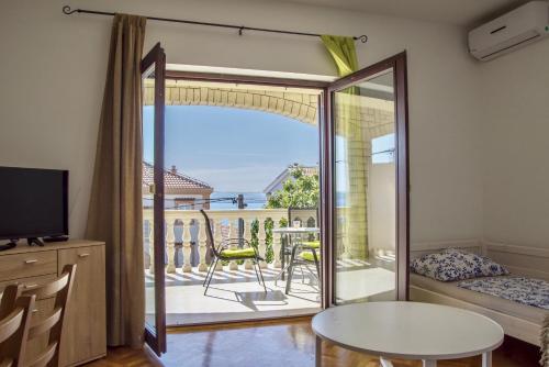 a room with a sliding glass door leading to a balcony at Lux dodo in Dramalj