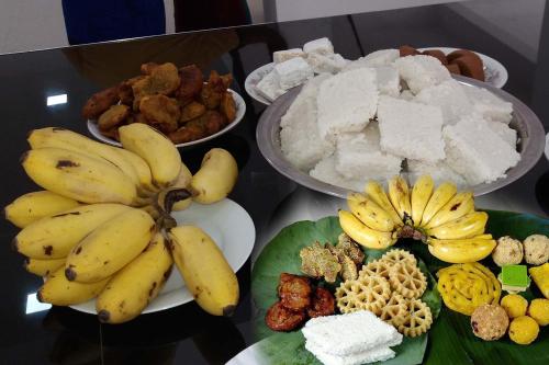 a bunch of bananas and other food on a table at Mountain White Villa by Sunrise in Kandy