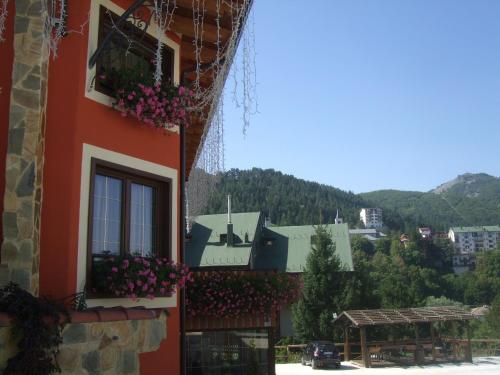 a building with flower boxes on the side of it at Garnì Astoria Hotel & SPA in Roccaraso