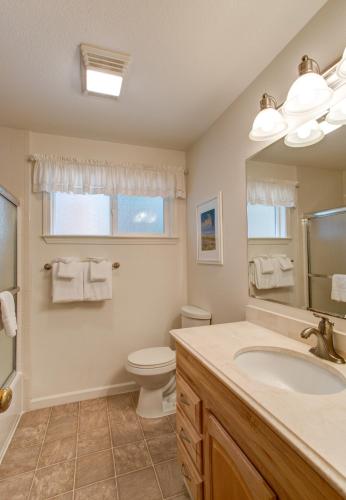 a bathroom with a sink and a toilet and a mirror at 11B Sequoia House in Wawona