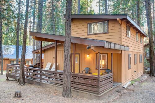 a cabin in the woods with a tree at 3A Cutters Edge in Wawona