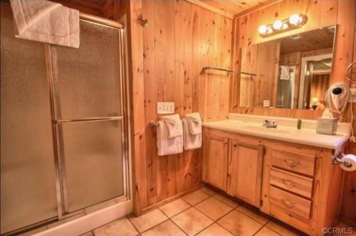 a bathroom with a shower and a sink at 95R The Little Creek Cabin in Wawona