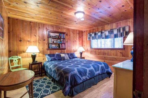 a bedroom with a bed in a wooden room at 50R Soots-Me in Wawona