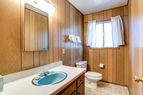 a bathroom with a sink and a toilet and a mirror at 9B Deer Hollow in Wawona