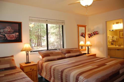 a bedroom with two beds and a window at 23A Big Cedar in Wawona