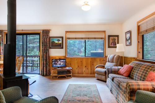 a living room with a couch and a stove at 1S Cecils Cabin in South Wawona