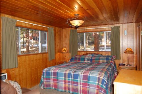 a bedroom with a bed in a wooden cabin at 6 Squirrels Nest in Wawona