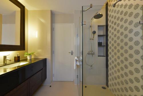 a bathroom with a shower and a sink at Altera Hotel and Residence by At Mind in Pattaya Central