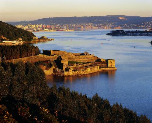 an island in the water with a city in the background at Hotel Valencia in Ferrol