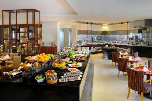 a buffet line with food on it in a restaurant at Crowne Plaza - Dubai Jumeirah by IHG in Dubai