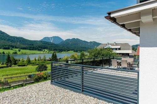 a balcony with a view of a lake and mountains at Ferienhaus Holzer in Weissensee