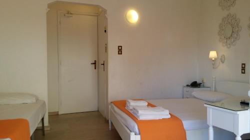 a hotel room with a bed and a lamp at Rachel Hotel in Agia Marina Aegina