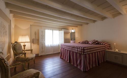 a bedroom with a bed and a chair and a window at Giraldi Property in Florence