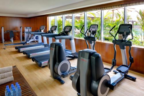 a gym with treadmills and elliptical machines at Crowne Plaza - Dubai Jumeirah by IHG in Dubai