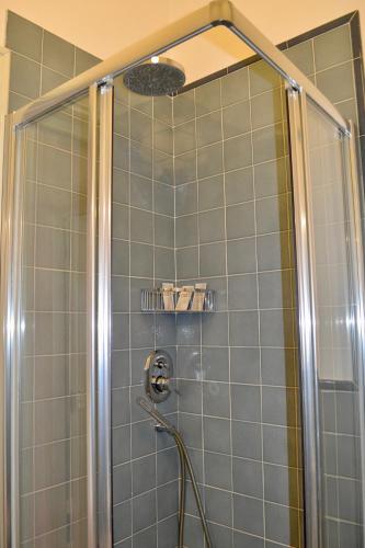 a bathroom with a shower with a glass door at La Maison du Paradis in Salerno
