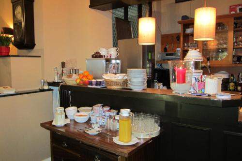 a kitchen with a counter with dishes on it at Hotel-Café-Burg Stahleck in Bacharach