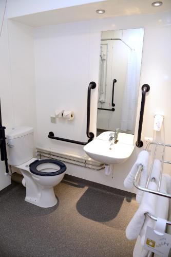 a bathroom with a toilet and a sink and a mirror at Lock Keeper, Worksop by Marston's Inns in Worksop