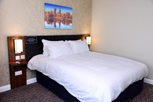 a large white bed in a hotel room at Lock Keeper, Worksop by Marston's Inns in Worksop