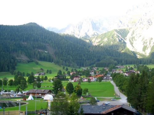 a town in a valley with a river and mountains at Appartement "Haus Lisa" in Ramsau am Dachstein in Ramsau am Dachstein