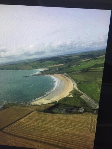 an aerial view of a beach and the ocean at Ocean View,Kinsale, Hosted by Exquisite holiday homes, sleeps 22 in Kinsale