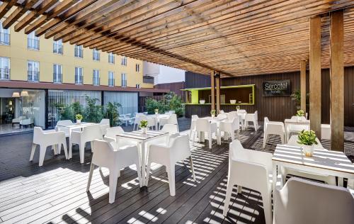 a dining room with tables and chairs and umbrellas at Sercotel Alcalá 611 in Madrid